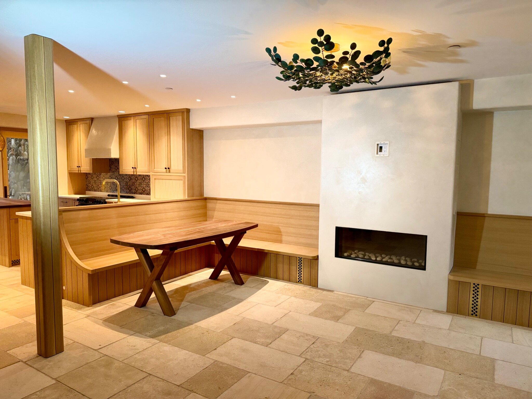 Completed custom kitchen, banquette, millwork, and fireplace project