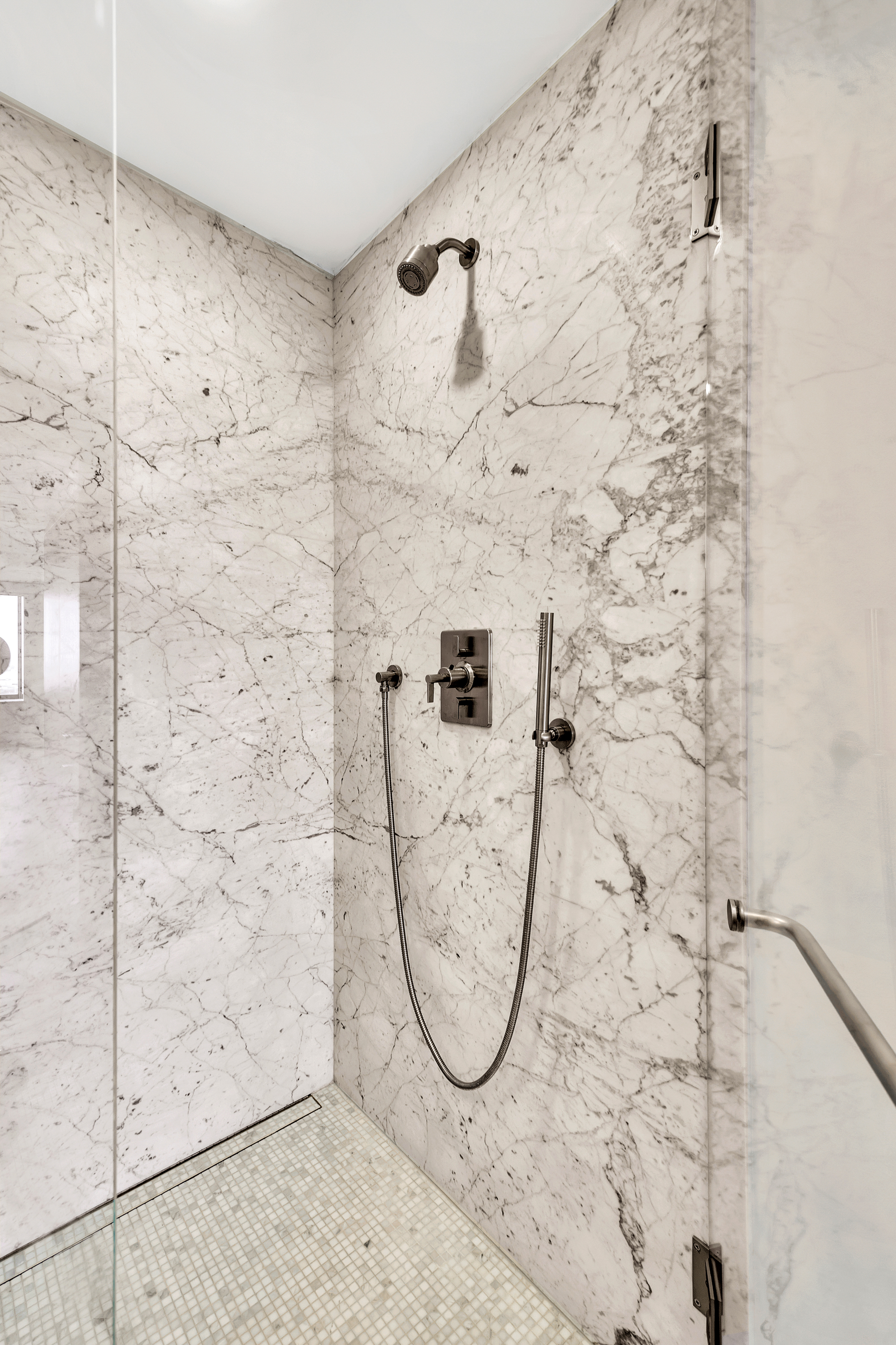 Marble shower with integrated fixtures in the Boston Harbor Flat