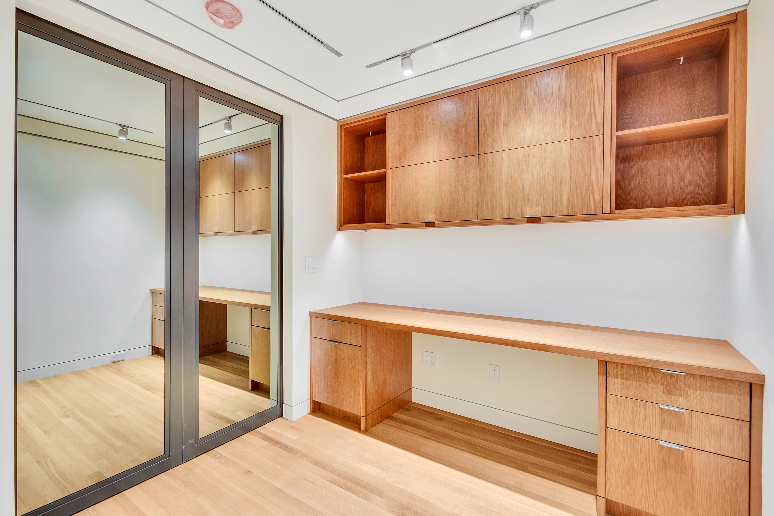 Integrated home office cabinetry and sliding glass partition