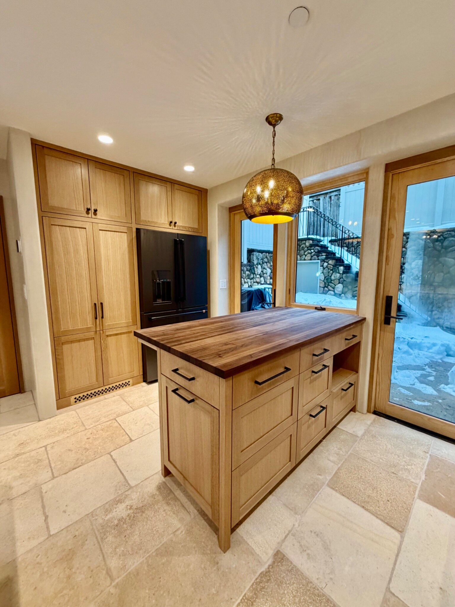 Custom white oak kitchen cabinetry and walnut island