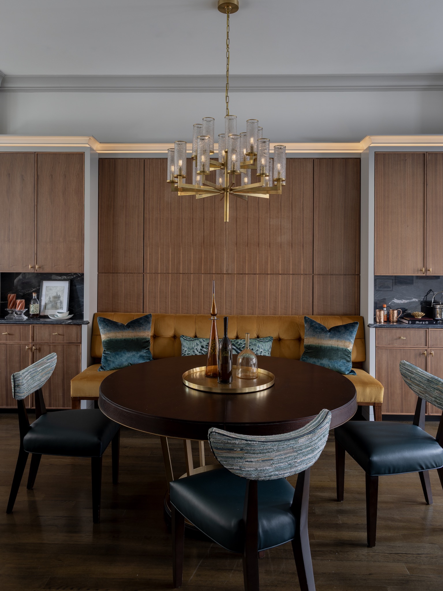 Full-height walnut cabinetry and upholstered dining banquette