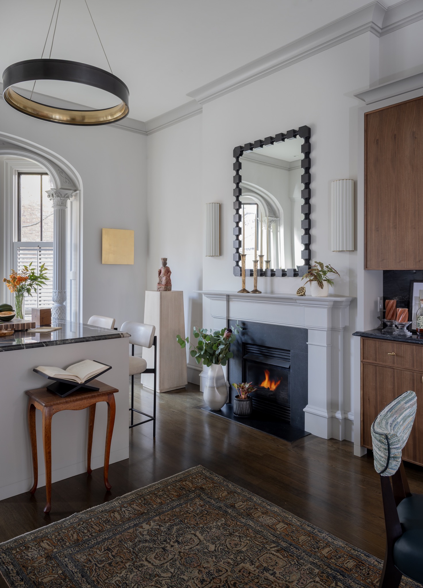 Living room fireplace framed by custom millwork